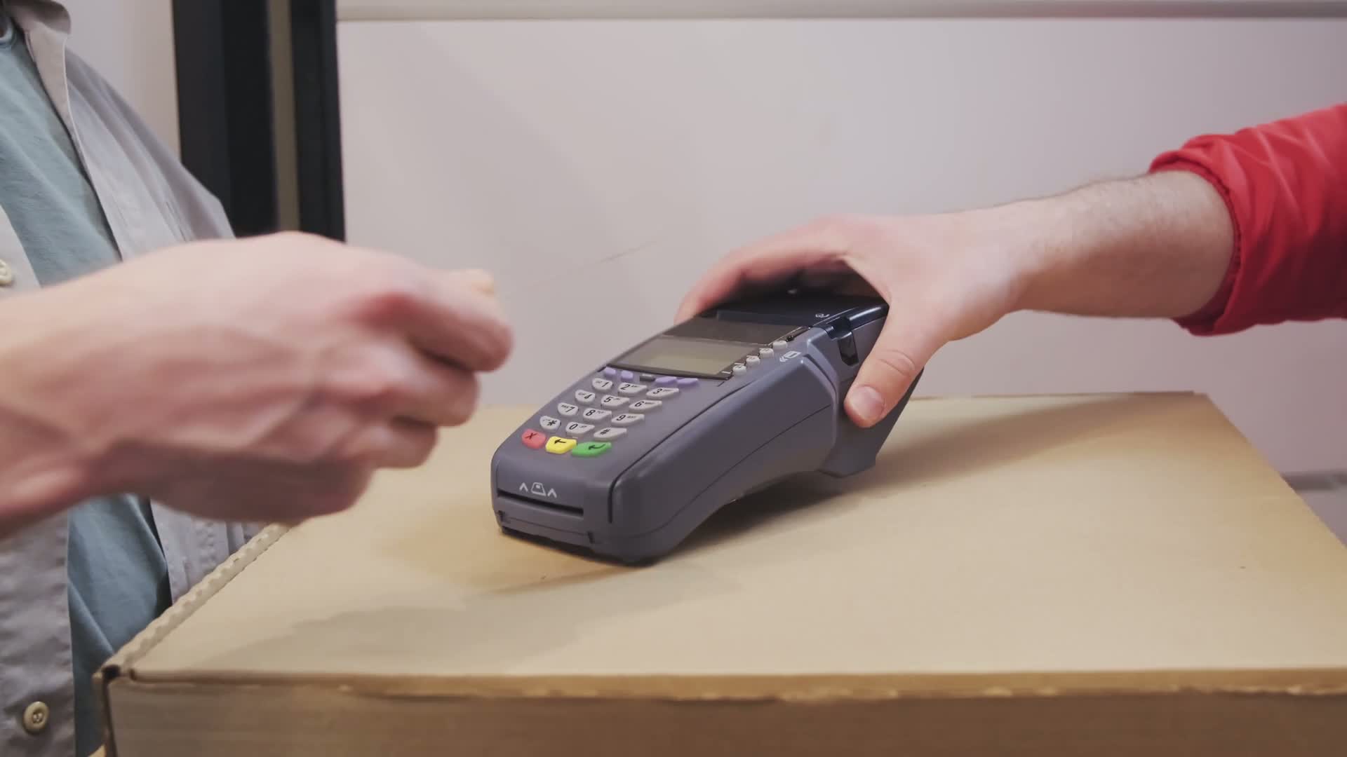 A customer paying by card at a payment terminal